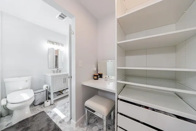 a room with a chair and a toilet