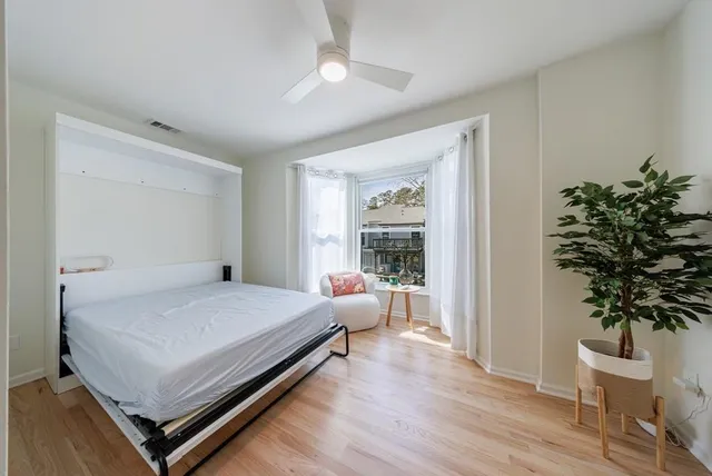 a bedroom with a bed and a chair