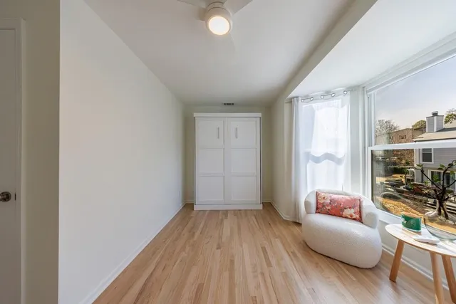 wooden floor in an empty room with a window