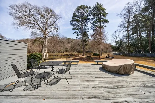 a view of a swimming pool with lounge chair and trees