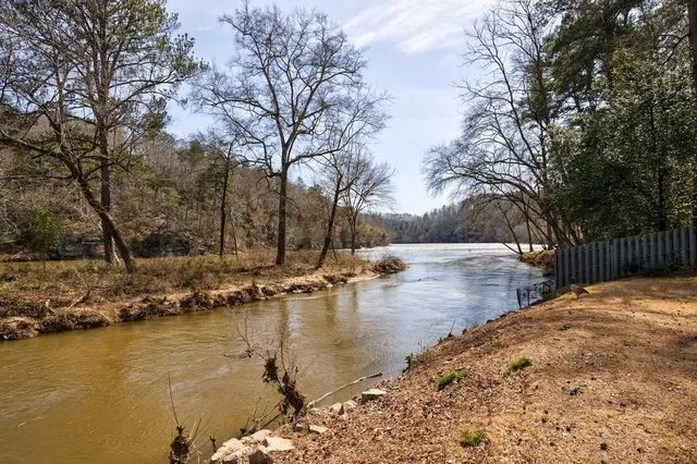 a view of swimming pool with trees and lake view