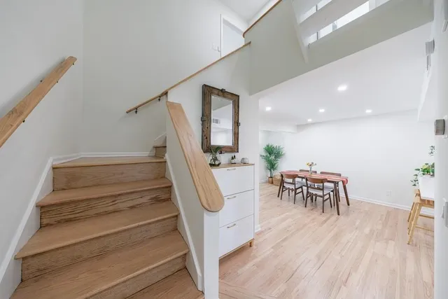 a view of entryway and hall with wooden floor