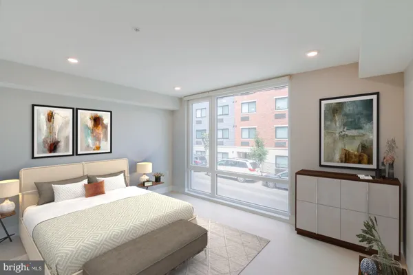 a bedroom with a large bed and a large window