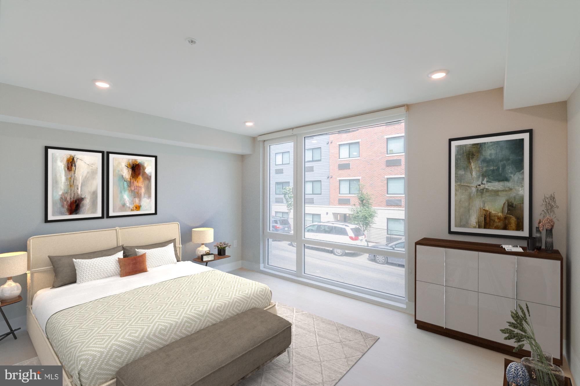 6604 Ridge Avenue, Unit 305 Philadelphia, PA 19128 - Photo 17 of 17 a bedroom with a large bed and a large window