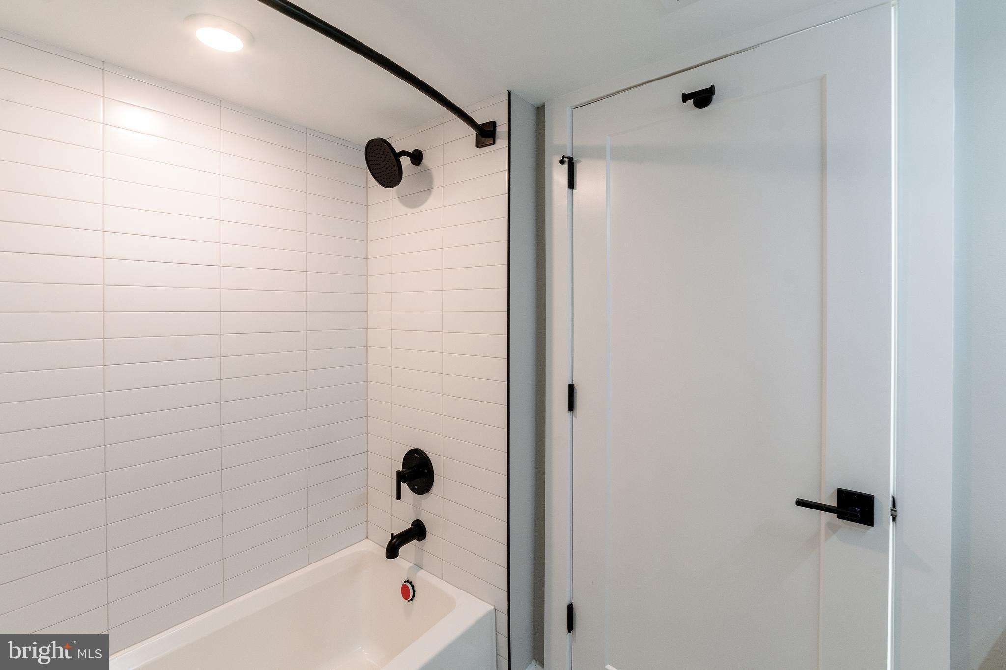 6604 Ridge Avenue, Unit 305 Philadelphia, PA 19128 - Photo 6 of 17 a bathroom with a shower and a bath tub
