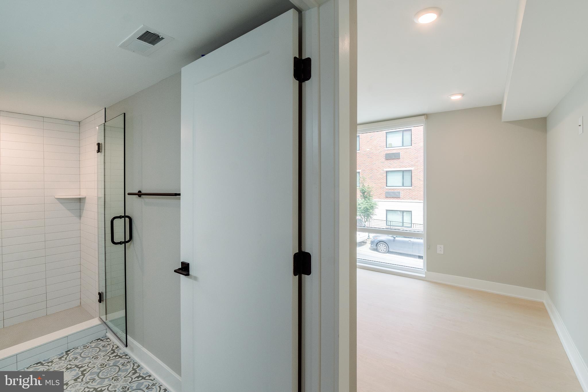 6604 Ridge Avenue, Unit 305 Philadelphia, PA 19128 - Photo 8 of 17 a view of a bathroom with a shower and a sink