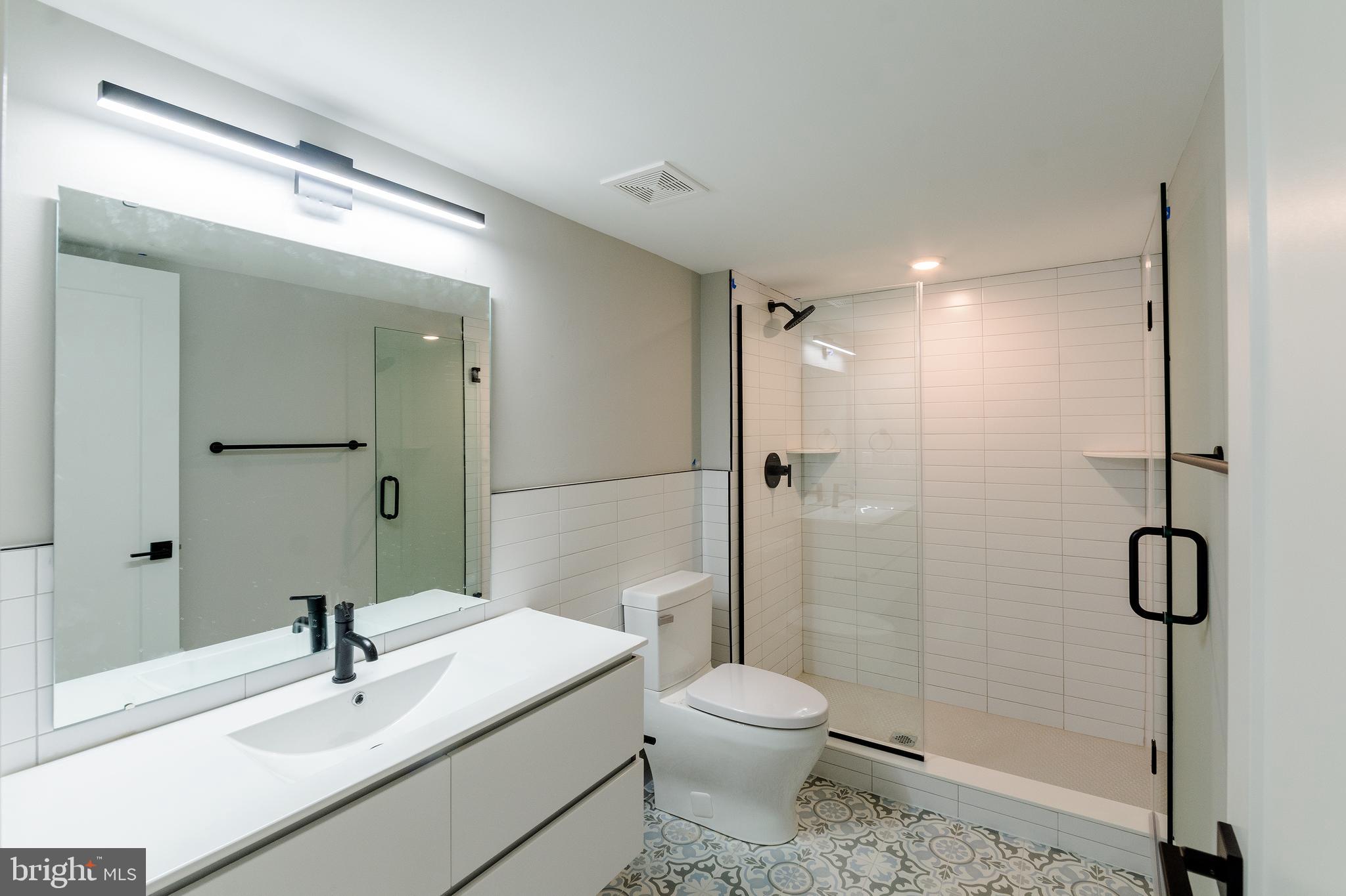 6604 Ridge Avenue, Unit 305 Philadelphia, PA 19128 - Photo 9 of 17 a bathroom with a sink a toilet and shower