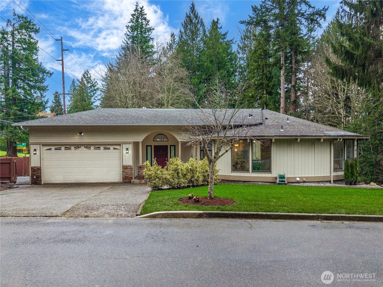 20709 Northeast 79th Street Redmond, WA 98053 - Photo 3 of 38 a front view of a house with a garden and plants