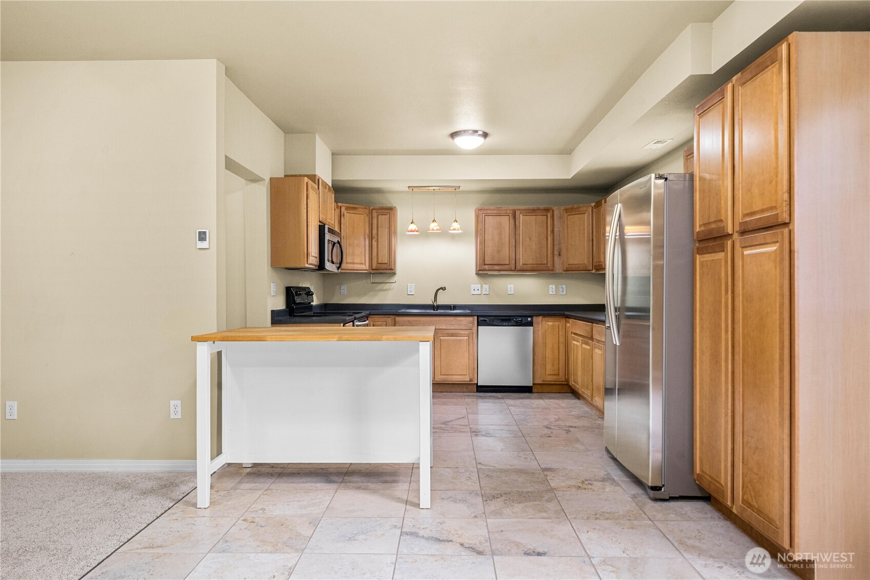 20709 Northeast 79th Street Redmond, WA 98053 - Photo 31 of 38 a kitchen with granite countertop a refrigerator and cabinets