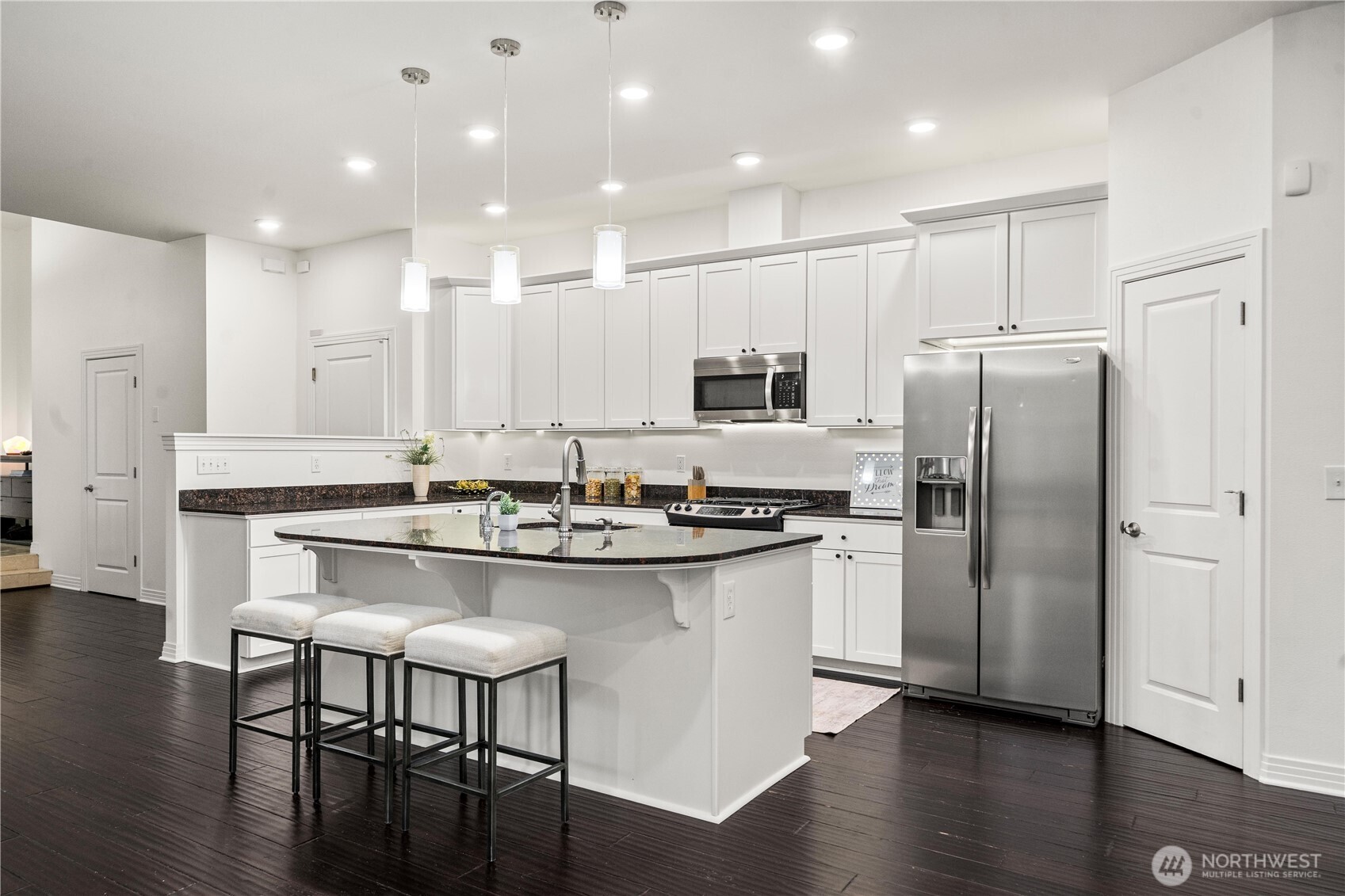 20709 Northeast 79th Street Redmond, WA 98053 - Photo 9 of 38 a kitchen with stainless steel appliances granite countertop a sink stove and refrigerator