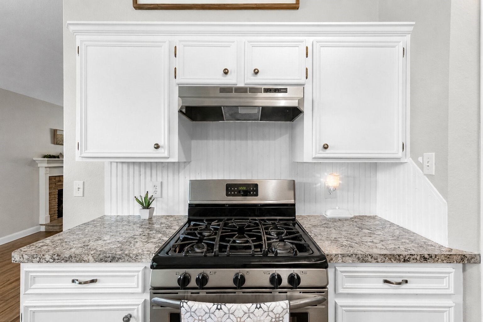 606 Walnut Street Sweeny, TX 77480 - Photo 11 of 28 a kitchen with granite countertop a stove and a white cabinets