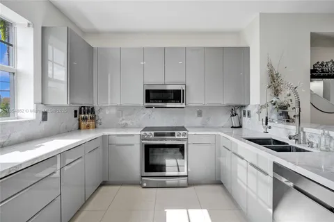 a kitchen with a sink stove and microwave