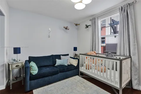 a view of a workspace with furniture and wooden floor