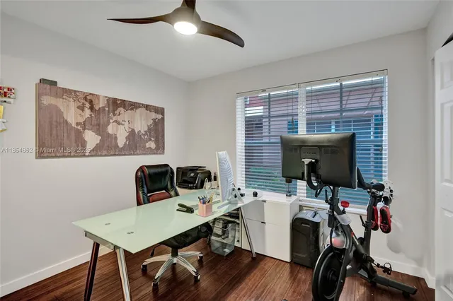 a bathroom with a granite countertop toilet sink and mirror
