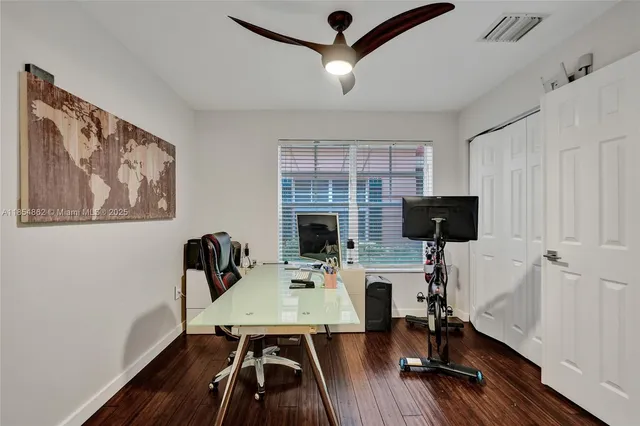 a bathroom with a granite countertop toilet a sink and a mirror
