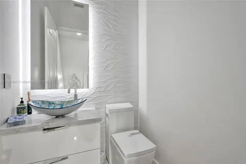 a view of a swimming pool with outdoor seating and plants