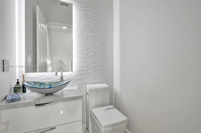 a view of a swimming pool with outdoor seating and plants