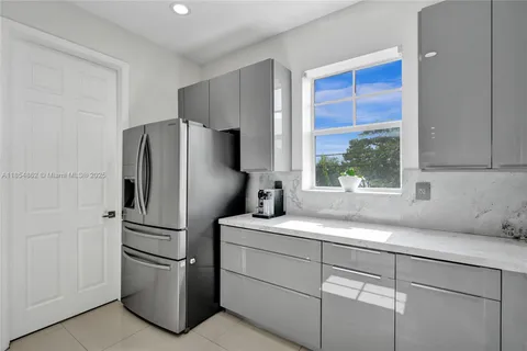 a kitchen with a table chairs a sink and a stove