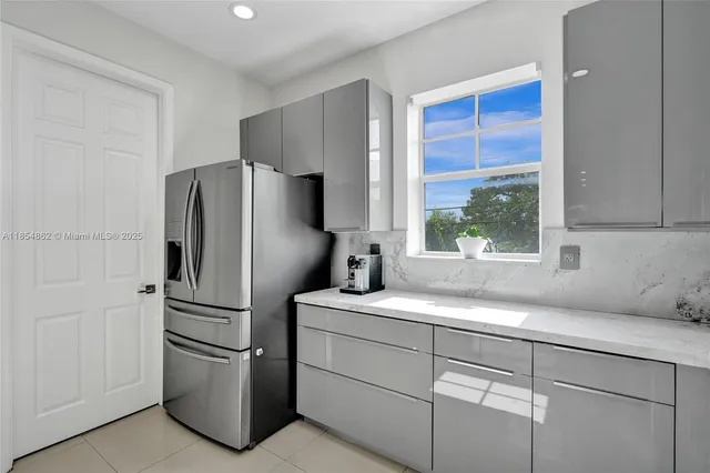 a kitchen with a table chairs a sink and a stove
