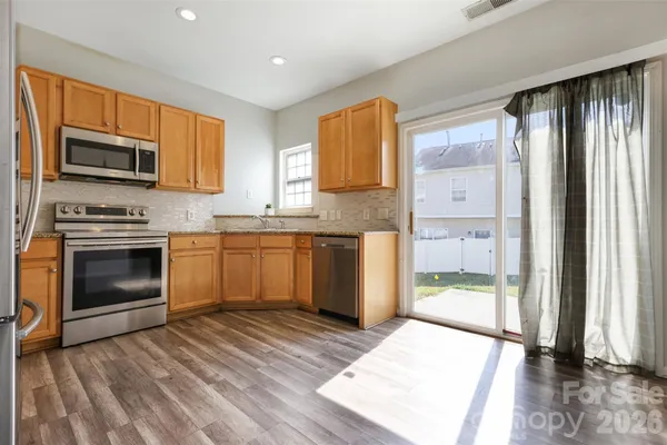 a kitchen with stainless steel appliances granite countertop a stove top oven sink and granite counter top