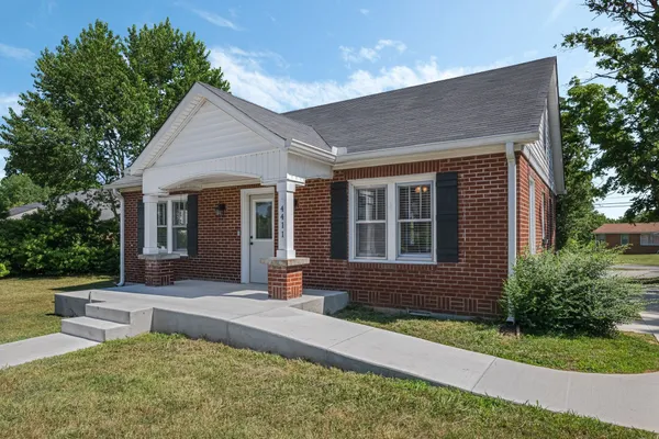 a view of house with backyard and garden