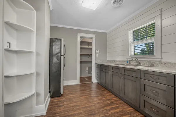 a kitchen with stainless steel appliances granite countertop a refrigerator and a sink