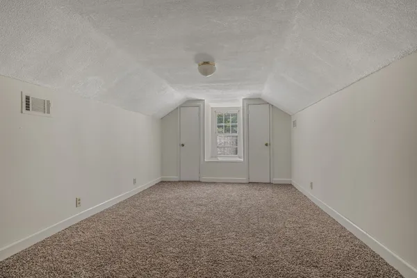 an empty room with a empty space and windows