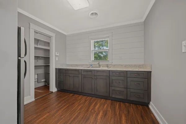 a room with a bed and a dresser