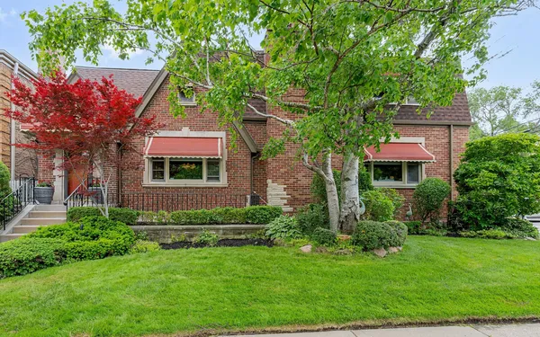 a front view of a house with a garden