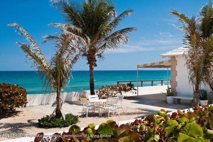 256 Mockingbird Trail Palm Beach, FL 33480 - Photo 18 of 31 a view of a patio with table and chairs potted plants and palm tree