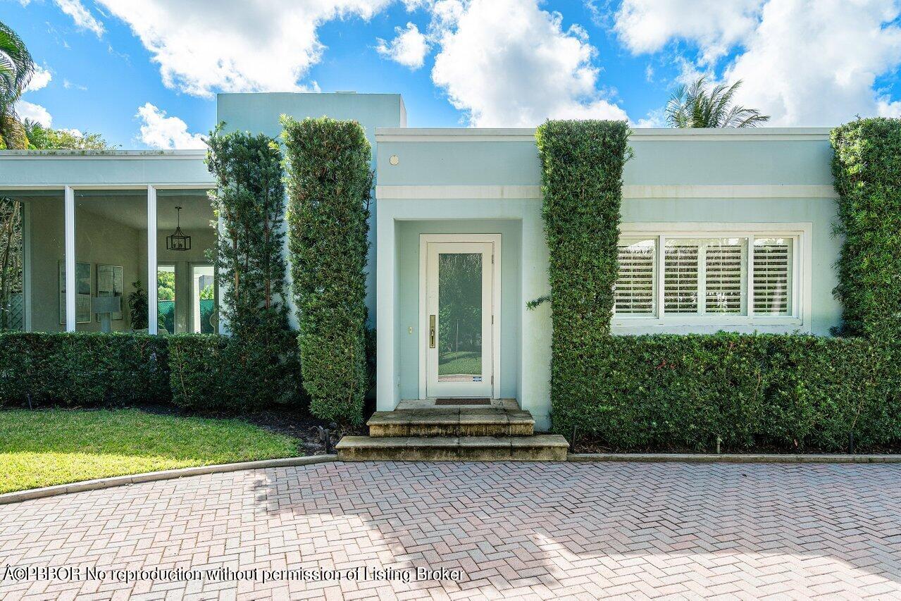 256 Mockingbird Trail Palm Beach, FL 33480 - Photo 2 of 31 a view of a house with a garden