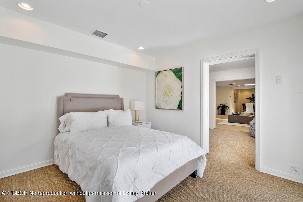 256 Mockingbird Trail Palm Beach, FL 33480 - Photo 24 of 31 a bedroom with a bed and a large mirror