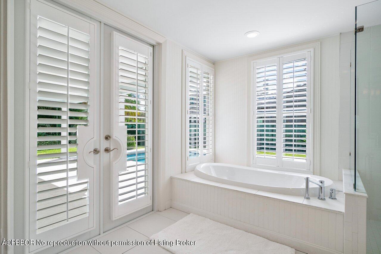 256 Mockingbird Trail Palm Beach, FL 33480 - Photo 9 of 31 a bathroom with sink bathtub and window