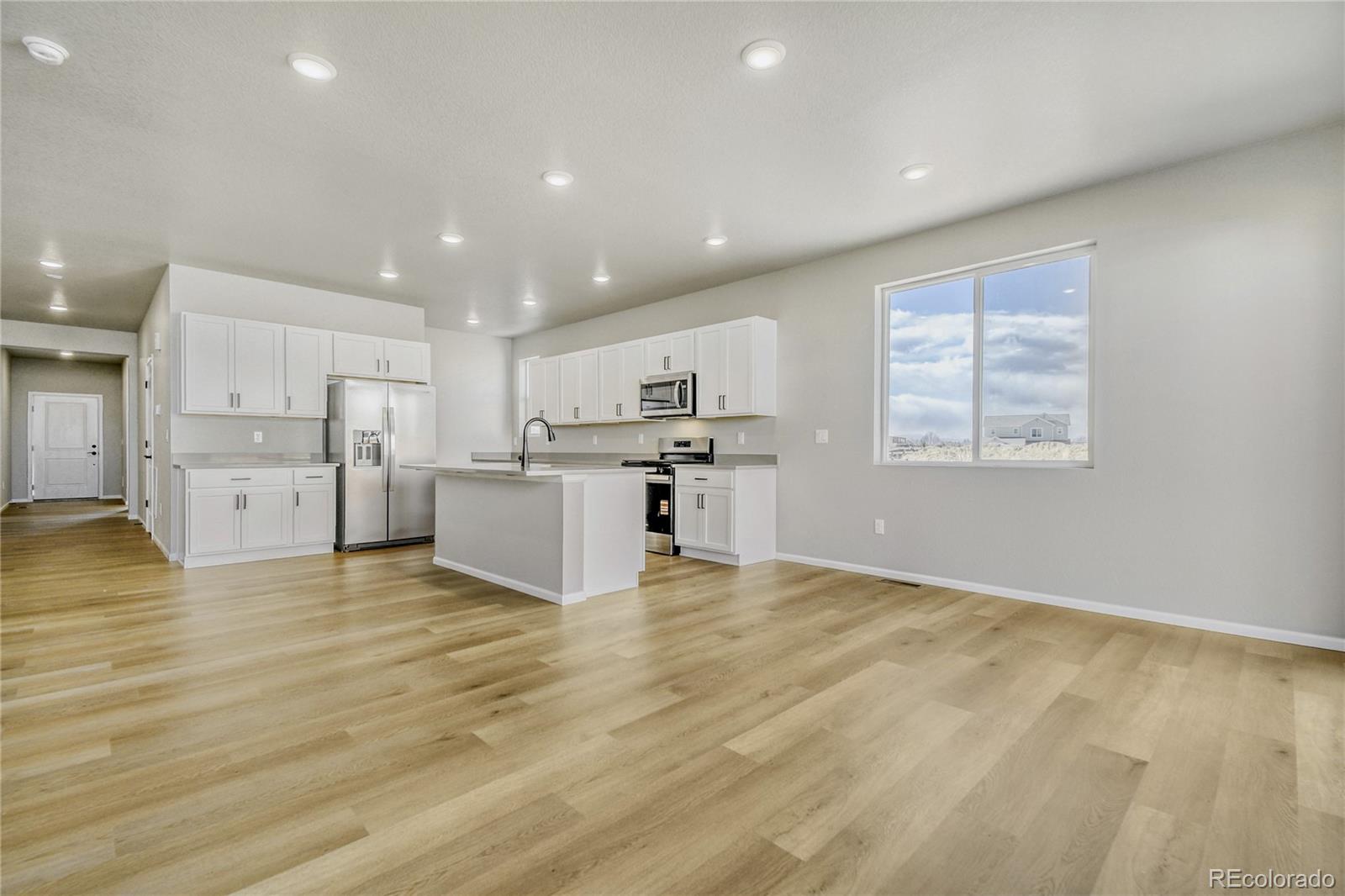 4135 Runyon Street Brighton, CO 80601 - Photo 11 of 27 a view of kitchen with furniture and wooden floor