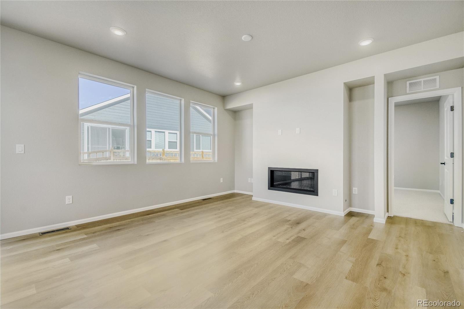 4135 Runyon Street Brighton, CO 80601 - Photo 12 of 27 an empty room with windows