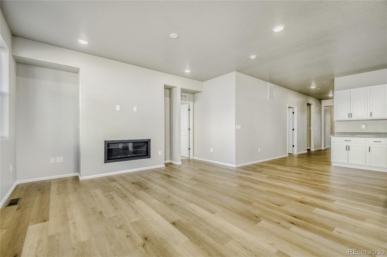 4135 Runyon Street Brighton, CO 80601 - Photo 14 of 27 a view of an empty room with a fireplace