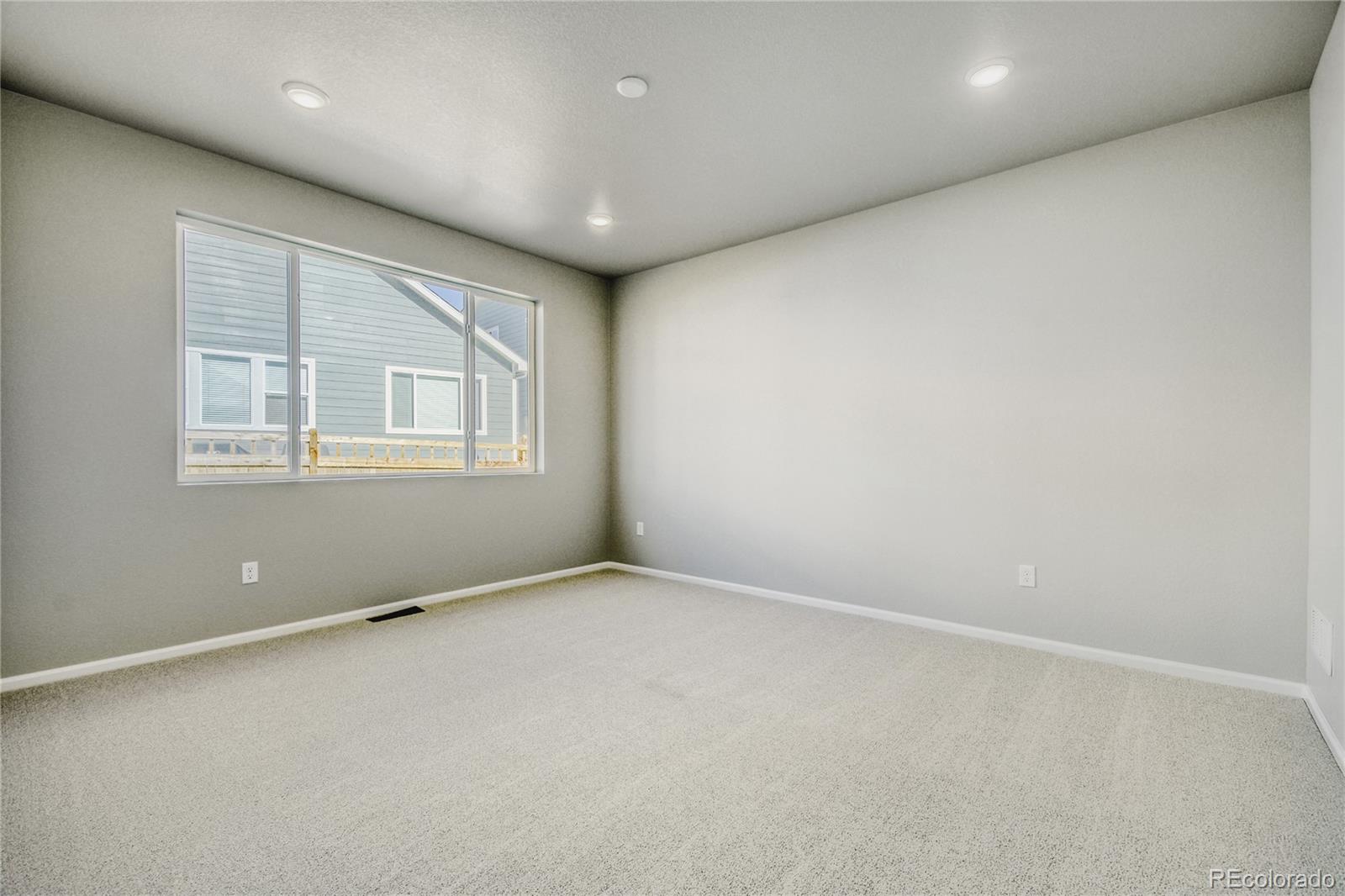 4135 Runyon Street Brighton, CO 80601 - Photo 15 of 27 an empty room with windows