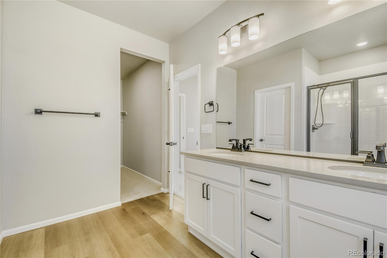 4135 Runyon Street Brighton, CO 80601 - Photo 18 of 27 a bathroom with a sink and a mirror