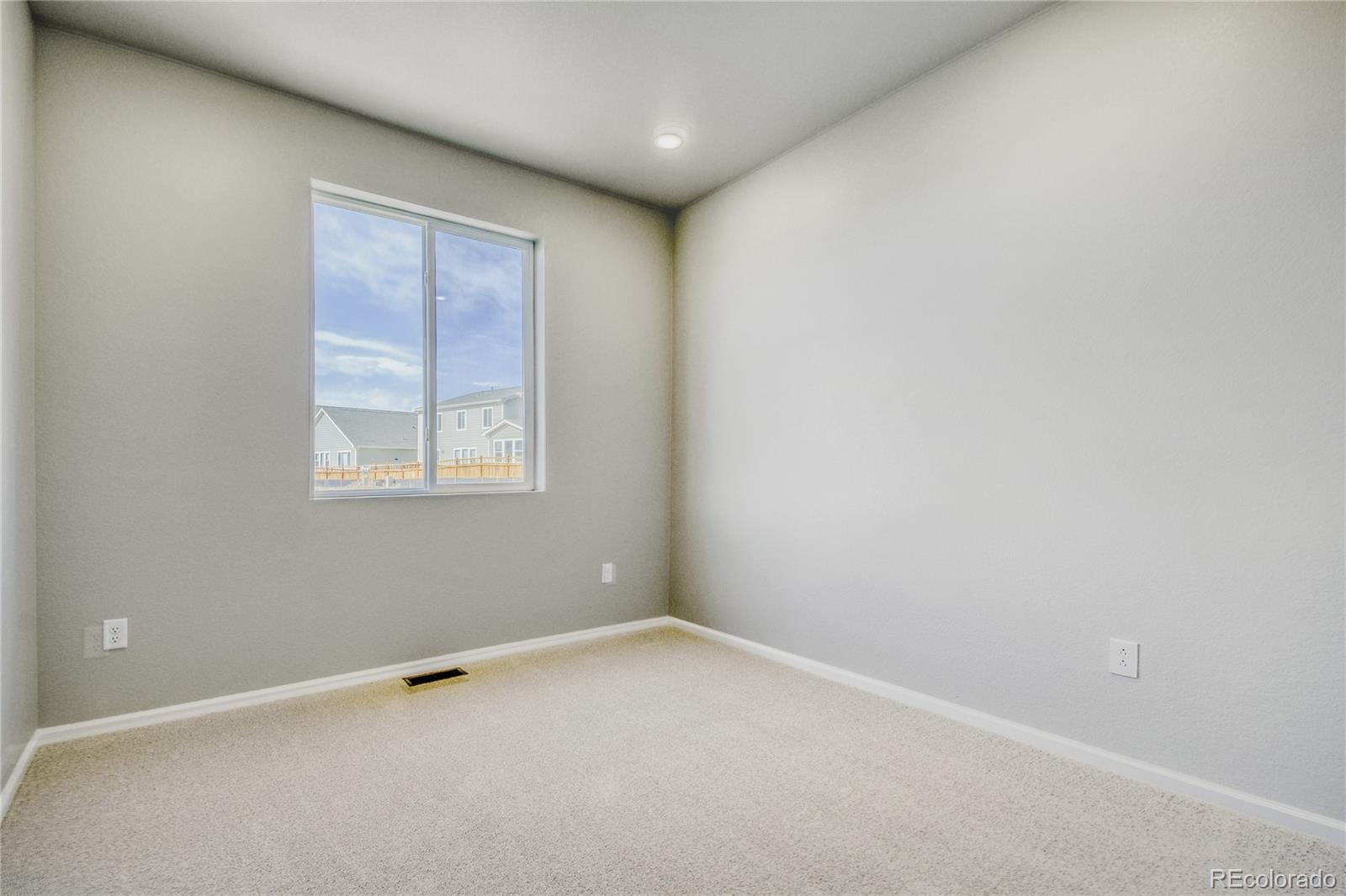 4135 Runyon Street Brighton, CO 80601 - Photo 23 of 27 an empty room with windows