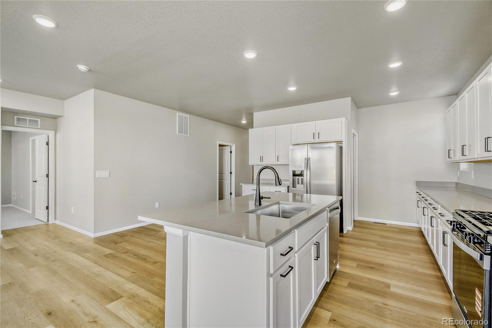 4135 Runyon Street Brighton, CO 80601 - Photo 7 of 27 a kitchen with stainless steel appliances granite countertop a sink and cabinets