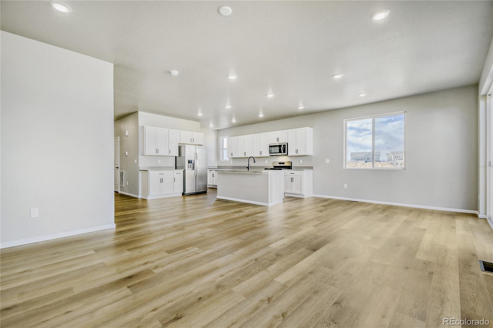 4135 Runyon Street Brighton, CO 80601 - Photo 10 of 27 a view of kitchen and wooden floor