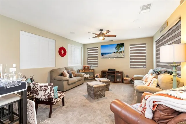 a bedroom with furniture and a large window