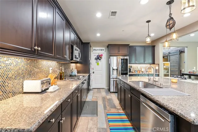 a kitchen with stainless steel appliances granite countertop lots of counter top space