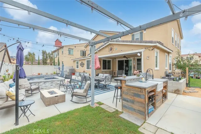 a view of a patio with couches table and chairs and potted plants