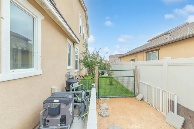a view of backyard of house with outdoor seating