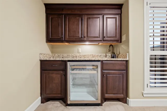 a kitchen with granite countertop white cabinets and stainless steel appliances