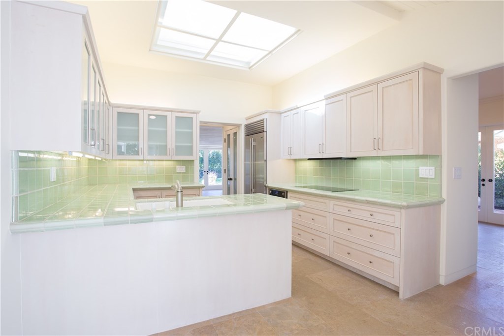 1 Seafaring Drive Corona del Mar, CA 92625 - Photo 11 of 25 a kitchen with granite countertop a sink and dishwasher a stove with wooden floor