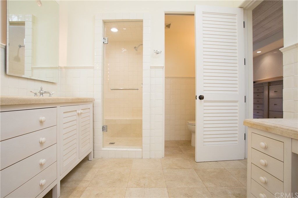 1 Seafaring Drive Corona del Mar, CA 92625 - Photo 19 of 25 a bathroom with a sink a mirror and a shower
