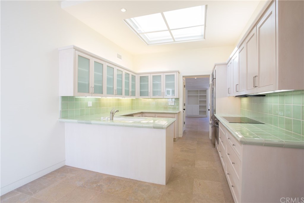 1 Seafaring Drive Corona del Mar, CA 92625 - Photo 10 of 25 a kitchen with granite countertop a sink and a stove