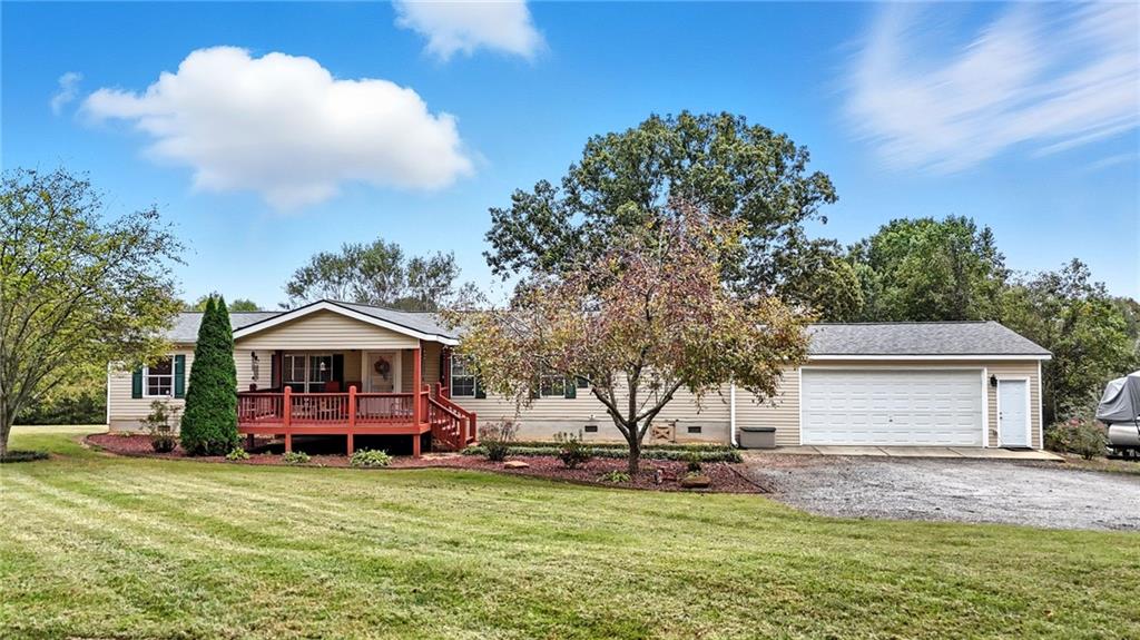 294 Old Ball Ground Road Canton, GA 30115 - Photo 12 of 40 a front view of a house with a garden and trees